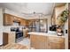 Well-lit kitchen featuring stainless steel appliances, ample counter space, and wood cabinets at 920 Mellowood Dr, Indianapolis, IN 46217