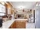 Kitchen features a breakfast bar and view into the other room with a fireplace at 920 Mellowood Dr, Indianapolis, IN 46217