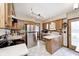 Traditional kitchen with stainless steel appliances, tiled floor and wooden cabinets at 920 Mellowood Dr, Indianapolis, IN 46217