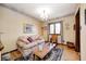 Cozy living room with a patterned sofa, hardwood floors, and a decorative chandelier at 920 Mellowood Dr, Indianapolis, IN 46217