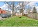 Large backyard area with grass, fence, and a detached garage at 953 N Oakland Ave, Indianapolis, IN 46201