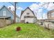 Spacious backyard featuring a grassy lawn and a partial fence at 953 N Oakland Ave, Indianapolis, IN 46201