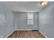Cozy bedroom with wood floors, fresh paint, and a window for natural light at 953 N Oakland Ave, Indianapolis, IN 46201
