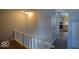 Hallway leading to kitchen and bathroom with wooden banister at 953 N Oakland Ave, Indianapolis, IN 46201