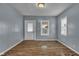 Bright living room with fresh paint, hardwood floors, and windows at 953 N Oakland Ave, Indianapolis, IN 46201