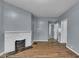 Open living room featuring a decorative fireplace and hardwood floors at 953 N Oakland Ave, Indianapolis, IN 46201