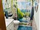 Stylish bathroom featuring a nature-themed shower curtain, white vanity, and coordinating blue accents at 1030 Pamela Dr, Plainfield, IN 46168