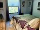 Bright bedroom featuring a floral comforter, window with blinds, and a closet with mirrored doors at 1030 Pamela Dr, Plainfield, IN 46168