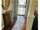 Inviting foyer with dark wood floors, decorative mirror, and patterned entry rug at 1030 Pamela Dr, Plainfield, IN 46168