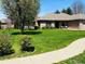 Manicured front lawn featuring mature trees and well-kept landscaping at 1030 Pamela Dr, Plainfield, IN 46168