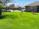 Wide open, vibrant front yard featuring mature trees and lush green grass at 1030 Pamela Dr, Plainfield, IN 46168