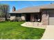 Charming brick home featuring a landscaped front yard and inviting front patio area at 1030 Pamela Dr, Plainfield, IN 46168