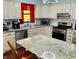 Bright kitchen featuring white cabinets, granite countertops, and stainless steel appliances at 1030 Pamela Dr, Plainfield, IN 46168