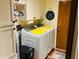 Functional laundry room featuring a front-load washer and dryer, storage cabinets, and decor at 1030 Pamela Dr, Plainfield, IN 46168
