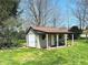 Outdoor shed with covered porch, offering extra storage and workspace in a landscaped backyard at 1030 Pamela Dr, Plainfield, IN 46168