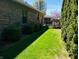 Brick home exterior and back deck with meticulously maintained green side yard at 1030 Pamela Dr, Plainfield, IN 46168