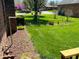 Well-maintained side yard with lush lawn, manicured bushes, and vibrant foliage at 1030 Pamela Dr, Plainfield, IN 46168