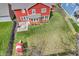 Aerial view of backyard with patio, lush lawn, and play area, showcasing outdoor living spaces near red siding home at 10603 Hinterland Dr, Fishers, IN 46038
