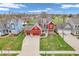 Aerial view of a colorful home with a well-manicured lawn, three-car garage, and inviting front porch near community park at 10603 Hinterland Dr, Fishers, IN 46038