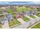 Community aerial view highlighting colorful homes, mature trees, and a vast green space, creating a scenic neighborhood at 10603 Hinterland Dr, Fishers, IN 46038