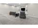 Finished basement features a futon, recliner, carpet, and built-in shelving at 10603 Hinterland Dr, Fishers, IN 46038