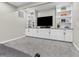 Basement area features carpet, built-in shelving, a TV and neutral paint at 10603 Hinterland Dr, Fishers, IN 46038