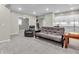 Basement space with a futon, recliner, carpet, and snack bar with white cabinets at 10603 Hinterland Dr, Fishers, IN 46038