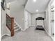 Spacious finished basement area with carpet, staircase, and exercise equipment at 10603 Hinterland Dr, Fishers, IN 46038