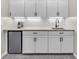 Basement snack bar with white subway tile backsplash, mini fridge, and granite counters at 10603 Hinterland Dr, Fishers, IN 46038