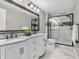 Beautiful bathroom with double sink vanity, large framed mirror, and walk-in shower at 10603 Hinterland Dr, Fishers, IN 46038