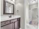 Bathroom with dark wood vanity, white marble floors, and a decorative framed mirror at 10603 Hinterland Dr, Fishers, IN 46038