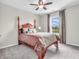 Bedroom with 4-poster bed, fan, and natural light at 10603 Hinterland Dr, Fishers, IN 46038