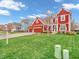 View of a two-story home with red siding, attached garage, and a lush green lawn at 10603 Hinterland Dr, Fishers, IN 46038