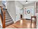 Inviting foyer showcasing hardwood floors, staircase and lots of natural light at 10603 Hinterland Dr, Fishers, IN 46038