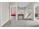 Hallway with neutral carpet featuring bedroom doorways and a stairway to the second floor at 10603 Hinterland Dr, Fishers, IN 46038