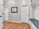 Hallway with hardwood floors, a mirror, and coat hooks near the entrance at 10603 Hinterland Dr, Fishers, IN 46038