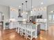 Modern kitchen featuring white cabinets, granite countertops, a stylish island, and stainless-steel appliances at 10603 Hinterland Dr, Fishers, IN 46038