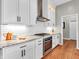 Modern kitchen design showcasing white cabinets, subway tile backsplash, stainless steel oven, and granite countertops at 10603 Hinterland Dr, Fishers, IN 46038