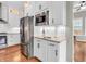 Stylish kitchen with stainless steel appliances, white cabinets, granite countertops, and under-cabinet lighting at 10603 Hinterland Dr, Fishers, IN 46038