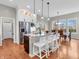 Open kitchen with a central island, modern appliances, and adjacent dining area with a window view at 10603 Hinterland Dr, Fishers, IN 46038