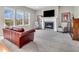 Cozy living room featuring a fireplace, large windows, and comfortable seating at 10603 Hinterland Dr, Fishers, IN 46038