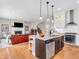 Open floor plan showcasing the kitchen, living room with fireplace, and dining area, perfect for modern living at 10603 Hinterland Dr, Fishers, IN 46038