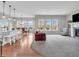 Open-concept living space featuring a kitchen island with seating, dining area, living room and fireplace at 10603 Hinterland Dr, Fishers, IN 46038