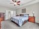 Spacious main bedroom boasts tray ceilings, fan, and double doors to the main bathroom at 10603 Hinterland Dr, Fishers, IN 46038