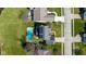 Aerial view of a home with a pool, solar panels, and lush landscaping in a desirable neighborhood at 11050 Midnight Pass, Fishers, IN 46037