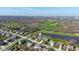 Aerial view of neighborhood, featuring a home overlooking a golf course and pond at 11050 Midnight Pass, Fishers, IN 46037