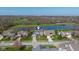 Aerial view of neighborhood, featuring a home overlooking golf course and pond at 11050 Midnight Pass, Fishers, IN 46037