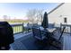 Back deck featuring outdoor furniture, an umbrella, and a view of the pond and golf course at 11050 Midnight Pass, Fishers, IN 46037