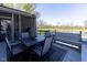 Back deck features outdoor furniture, an umbrella, and overlooks the pond and golf course at 11050 Midnight Pass, Fishers, IN 46037