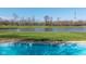Picturesque backyard featuring an in-ground pool, pond, and golf course views at 11050 Midnight Pass, Fishers, IN 46037